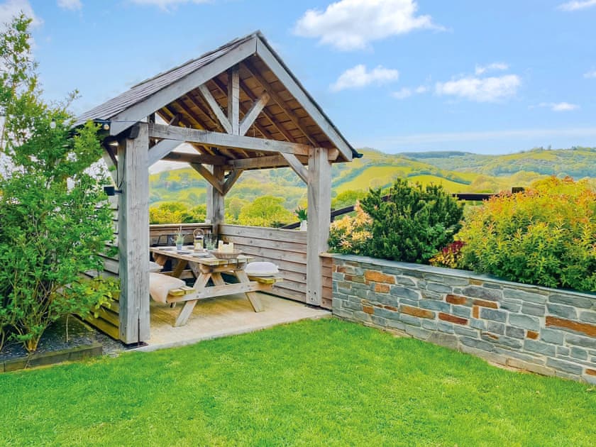 Sitting-out-area | Maes Y Bryn Farmhouse, Llansadwrn, near Llandeilo