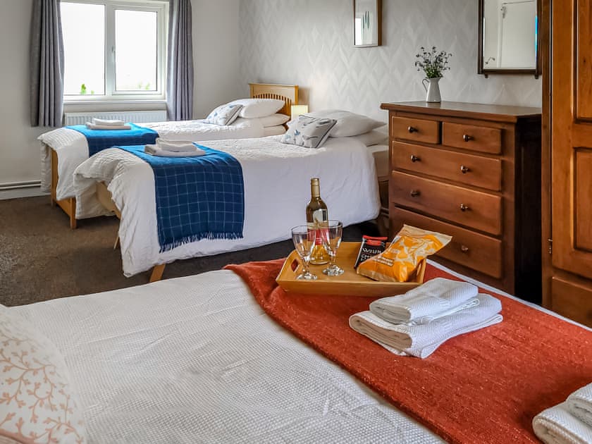 Spacious bedroom zip and link twin beds (can be super kingsize on request), single bed and pull-out bed | Bryn Boda, Nantglyn, near Denbigh