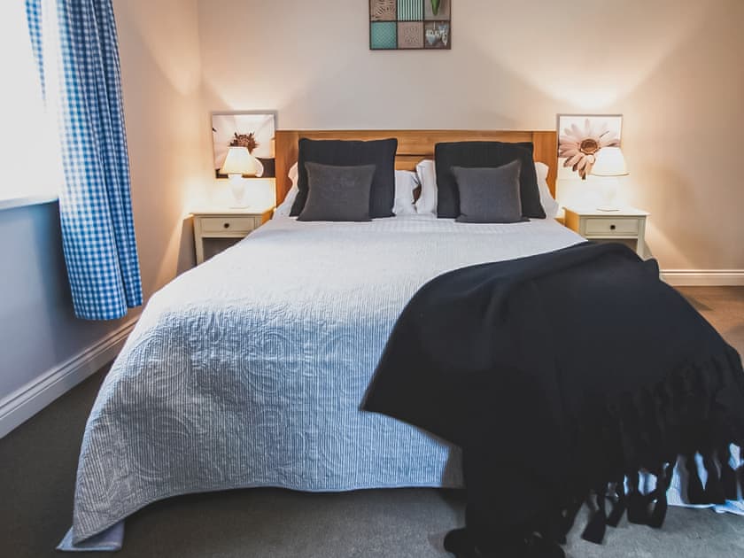 Comfortable kingsize bedroom, looking onto the river and adjacent field | The Mill Lodge, Bell Busk, near Skipton