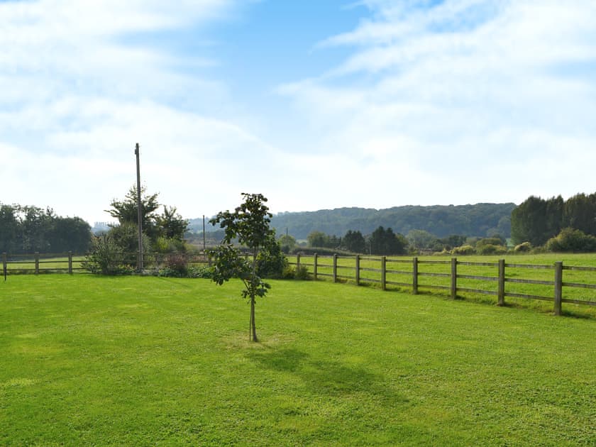 Garden surrounded by lush countryside | Blackberry Barn - Middle Huntingford Barns, Charfield, near Wotton-under-Edge