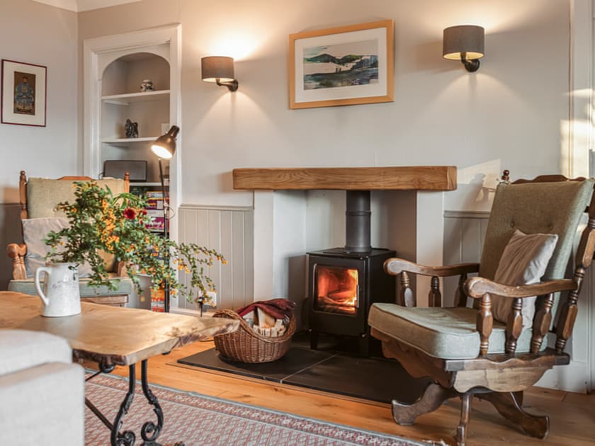 Cosy living room with open fire | Strathcashel Cottage, Rowardennan, near Balamaha
