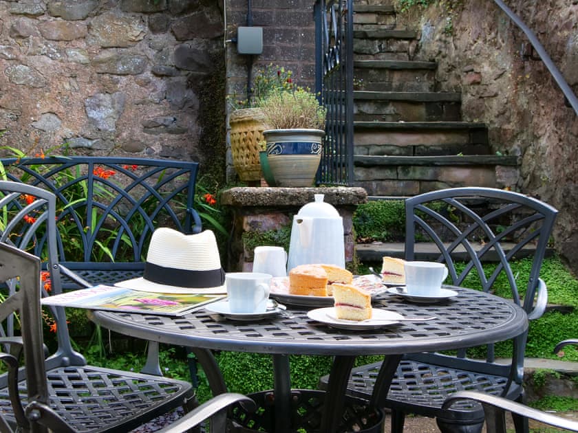 Delightful patio area with table and chairs | The Oval, Dunster