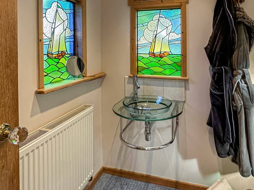 Beautiful stained glass windows in the shower room  | The Escape, South Hill, near Tamar Valley