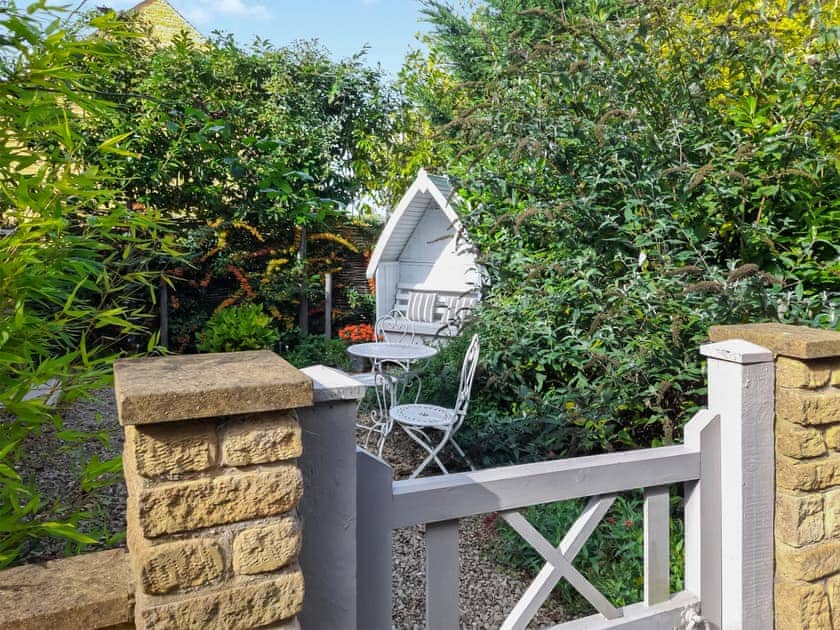 Fully enclosed garden with a patio and feature borders | The Apple Loft, Mickleton, near Chipping Campden