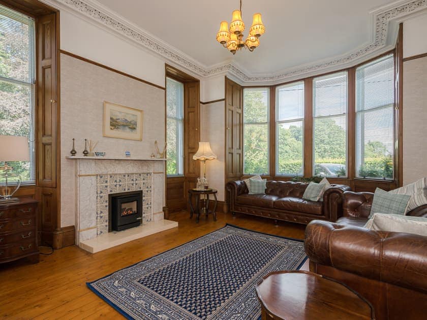 Cosy living room with wood burner | Albion House, Castle Douglas