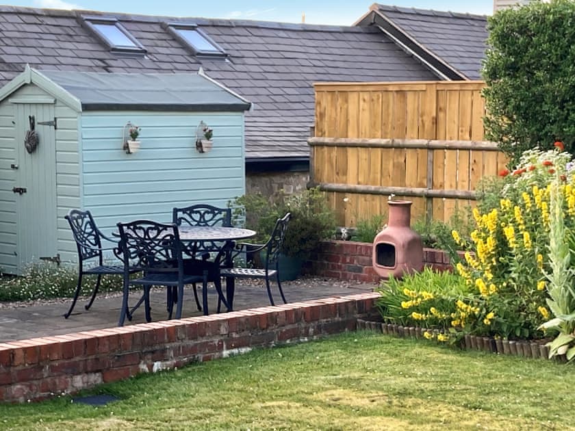Paved patio area with outdoor furniture | Donadea Cottage, Babell near Holywell