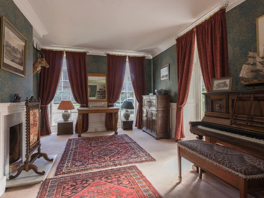 Drawing room with piano and open fire | The Sedgeford Hall - Sedgeford Hall Estate , Sedgeford, near Hunstanton