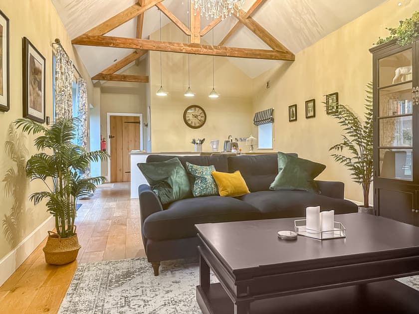 Spacious living area with exposed wooden roof trusses | Sykelands Cottage - Sykelands Grange Cottages, Dalton