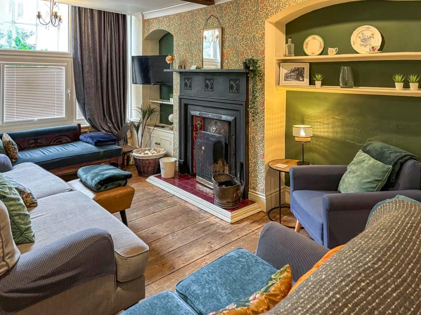 Cosy living room area with open coal/log fire | Nell’s Cottage, Bridlington