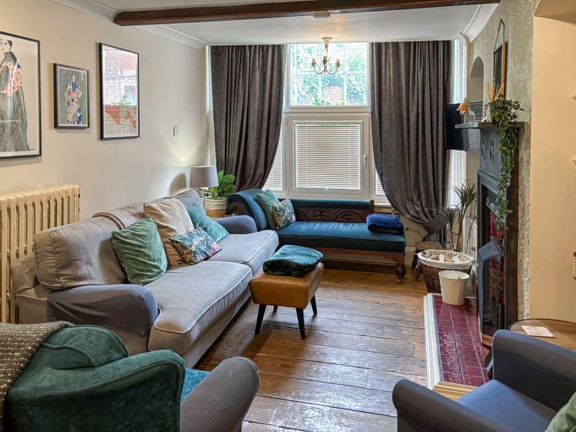 A lovely mix of vintage, upcycled  and new furniture in the beamed living space | Nell’s Cottage, Bridlington