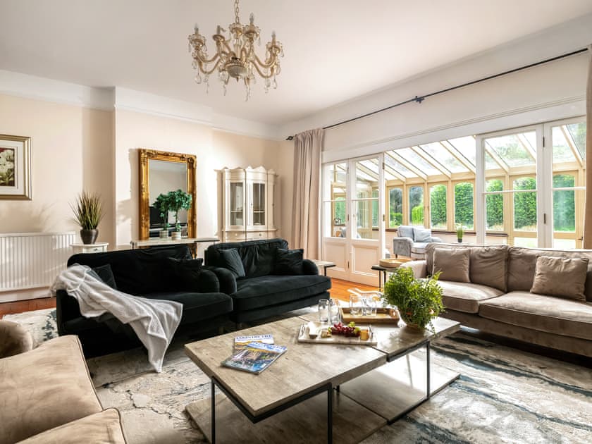 Living room leading into conservatory | Downwood Vineyard, Blandford