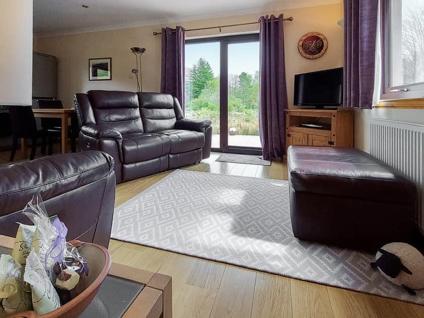 Living area with recliner leather chairs | Roe Deer Cottage, North Ballachulish, near Glencoe
