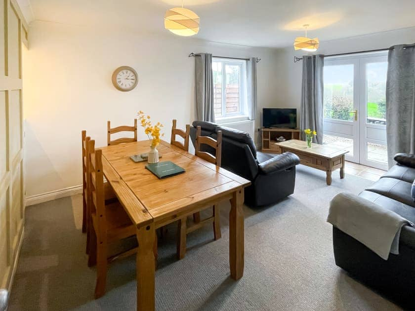 Relaxing living room with views out of the French doors across Dartmoor | Dartmoor View - Newbarn Farm, Collaton St Mary, near Paignton