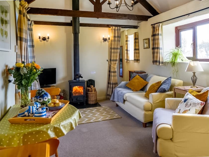 Exposed wood beams throughout the open-plan living space | The Byre - Mennabroom Farm Cottages, Warleggan, near Bodmin