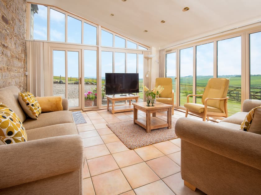 Living/ dining room with ceiling to floor windows | Grindon Cartshed, Grindon near Haydon Bridge