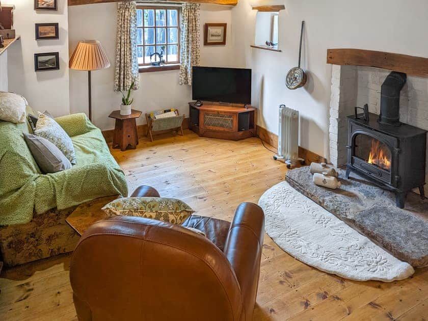 Cosy and warm living/dining room with wood burner | Harvest Cottage, Pen-y-Cae, near Ruabon