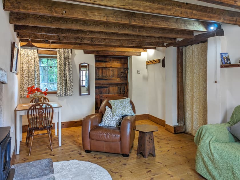 Cosy and warm living/dining room with wood burner | Harvest Cottage, Pen-y-Cae, near Ruabon