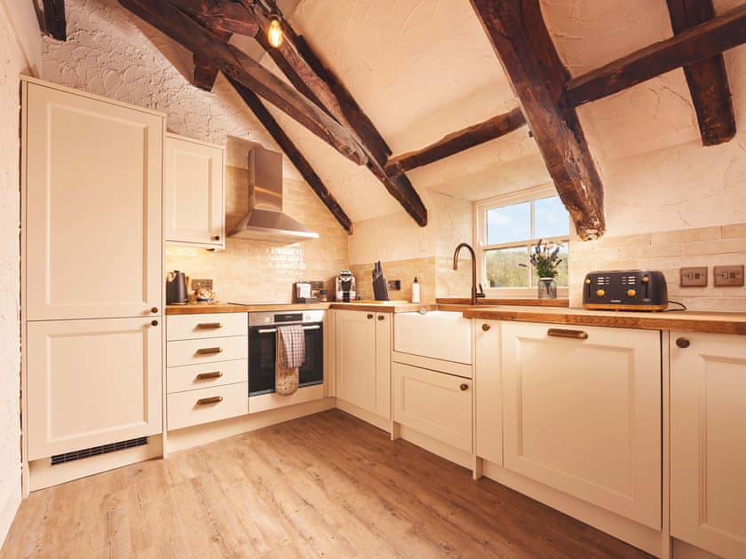 The modern fitted kitchen has built in appliances | Waterfront Apartment, Fowey