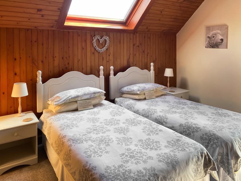 Lovely spacious twin bedroom with original wood lined walls and velux roof window  | Kirnan Cottage, Kilmichael Glassary, near Lochgilphead