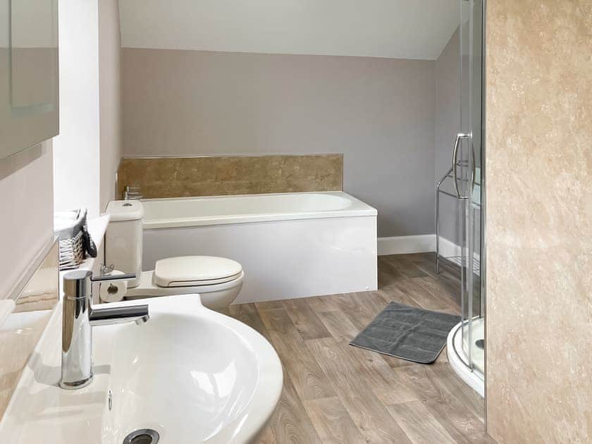 Bathroom with bath and shower cubicle | Halleaths Home Farm, Lochmaben