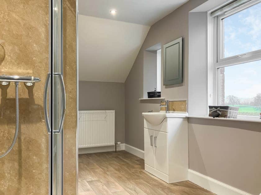Bathroom with bath and shower cubicle | Halleaths Home Farm, Lochmaben