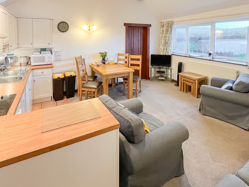 Comfy seating within the living area | Woodpecker - Manor Court Cottages, Shipton Gorge
