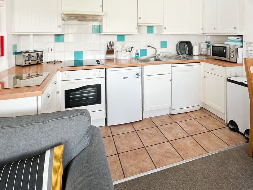 Fully-equipped fitted kitchen with convenient dining area | Woodpecker - Manor Court Cottages, Shipton Gorge