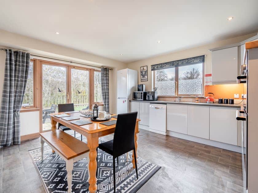 Large kitchen/diner with doors to the garden | Croftside House - Allt Mor Cottages, Aviemore