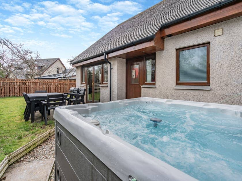 Relax in the lovely hot tub | Cairn View - Allt Mor Cottages, Aviemore