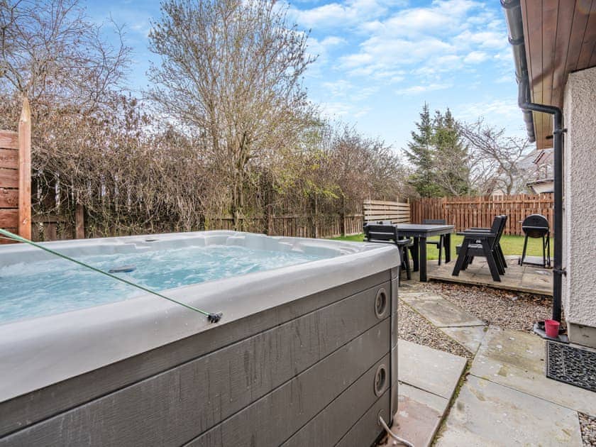 Relax in the lovely hot tub | Cairn View - Allt Mor Cottages, Aviemore