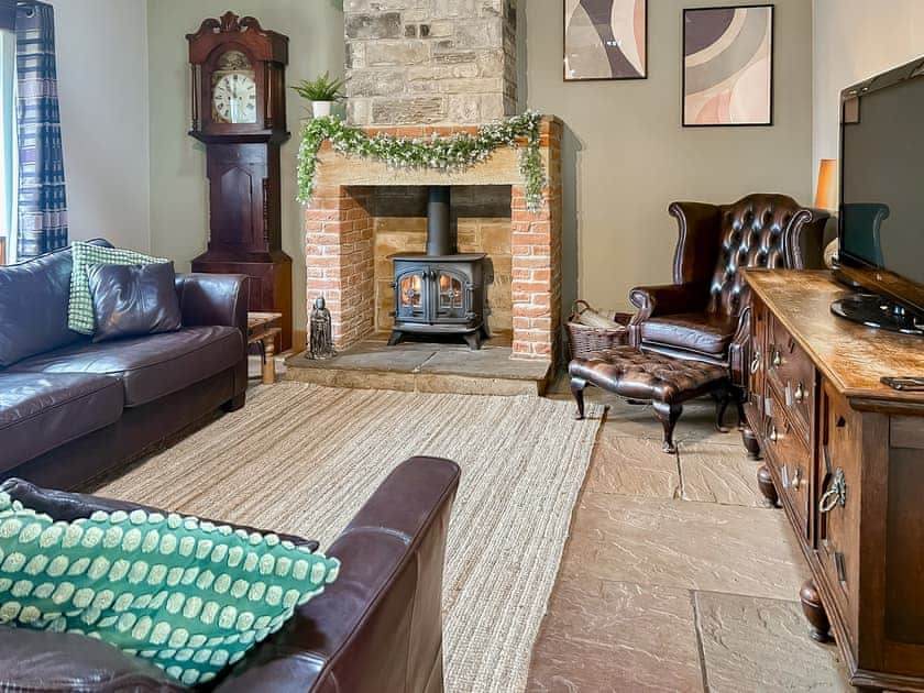 Cosy lounge with wood burning stove and wood beamed ceiling | Old Kielder Castle Cottage, Kielder, near Bellingham