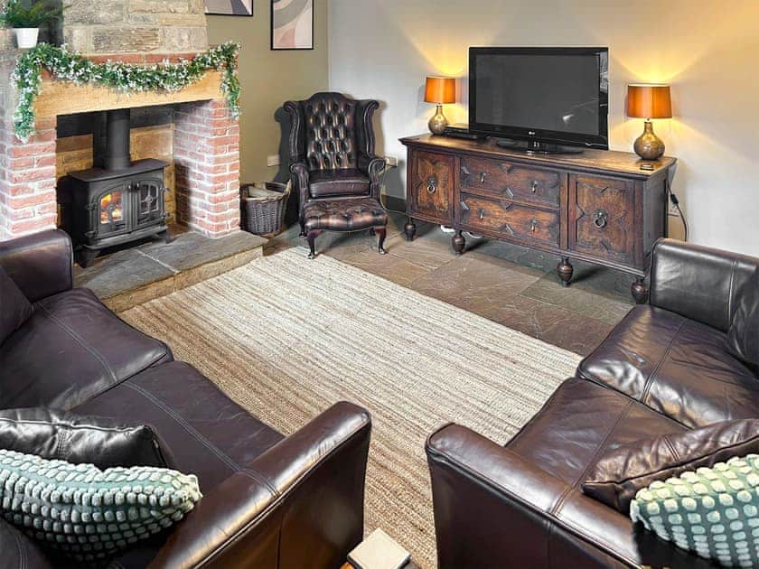 Cosy lounge with wood burning stove and wood beamed ceiling | Old Kielder Castle Cottage, Kielder, near Bellingham