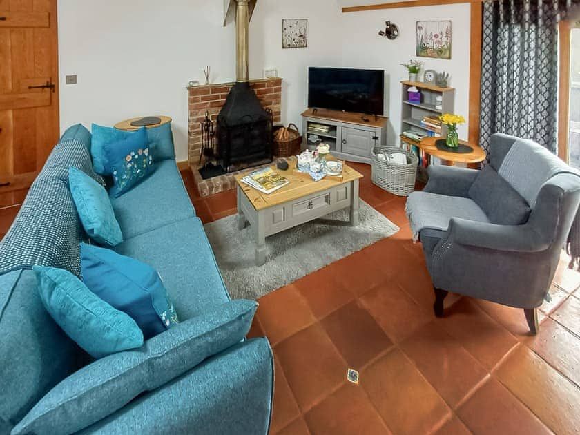 Delightful living room with cosy wood burner | Meadow Barn, East Burton, near Wool