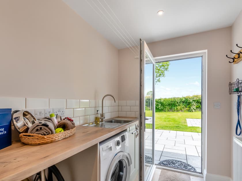 Utility room leading to garden and hot tub  | Llwyncelyn Farmhouse, Clynderwen