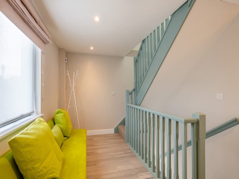 Stair landing with couch | Hollyhocks-  The Loft at The Gatehouse - Hollyhocks, Holt