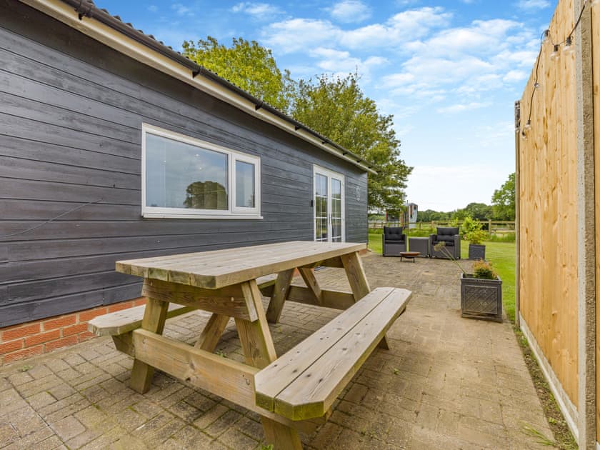 Sitting-out-area | Hawthorns Glamping- Squirrel Lodge - Hawthorns Glamping, Foxley, near Dereham