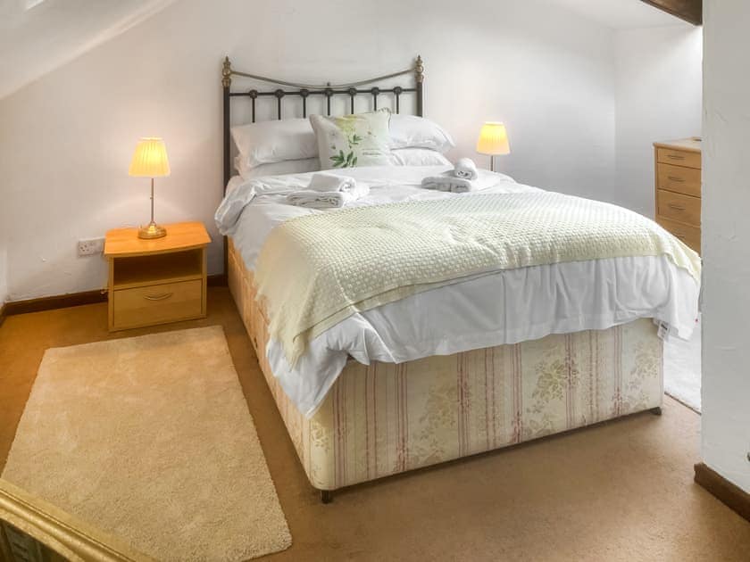 Double bedroom with antique style bed | Penny Croft - The Crofters Cottages, Llangeinor, near Bridgend