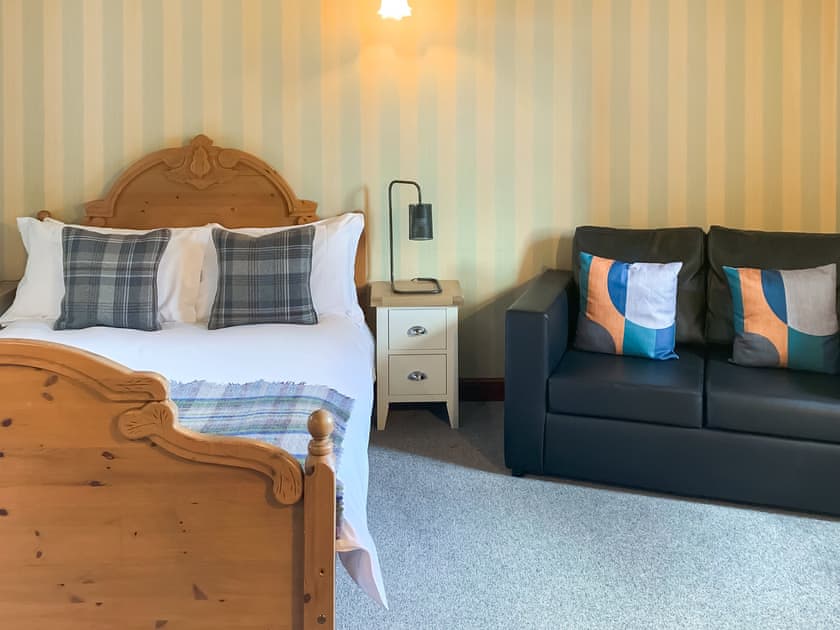 Downstairs bedroom with two seater safa and TV | Green Lane Cottage, Aberhafesp, near Newtown