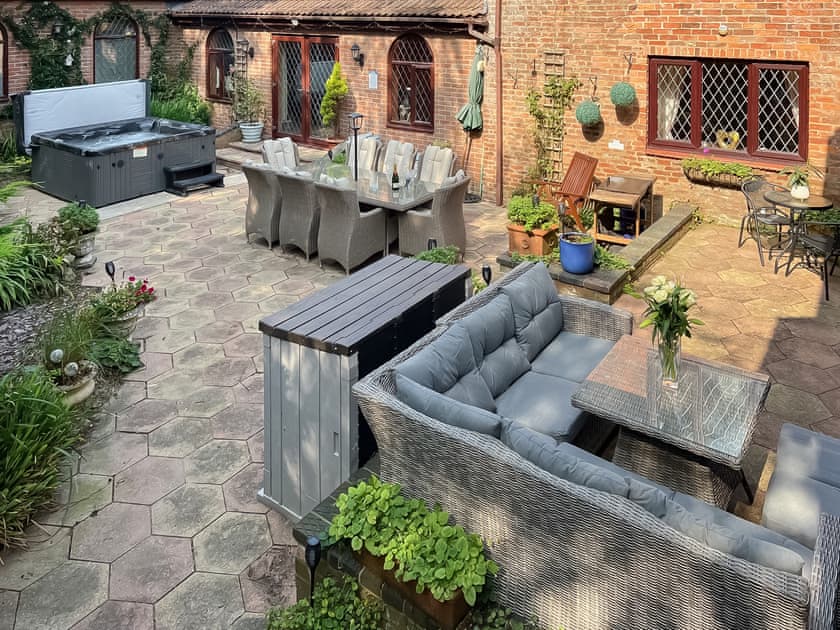 Patio area with hot tub and seating  | Lambourne House - Ashtree Court, Skegness