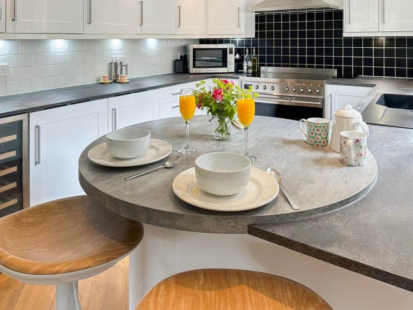 Remodelled kitchen showing its breakfast bar, bottle fridge and smeg induction range  | Tigh-na-Creige, Colintraive