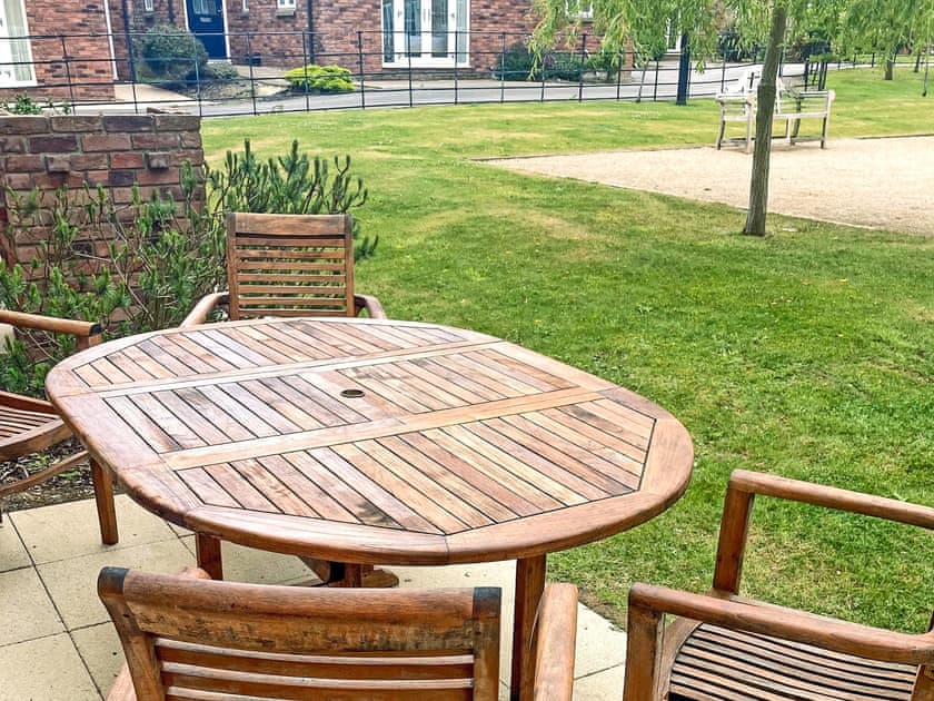 Patio and shared garden area | Sandy Bay Cottage - The Bay, Filey, near Scarborough