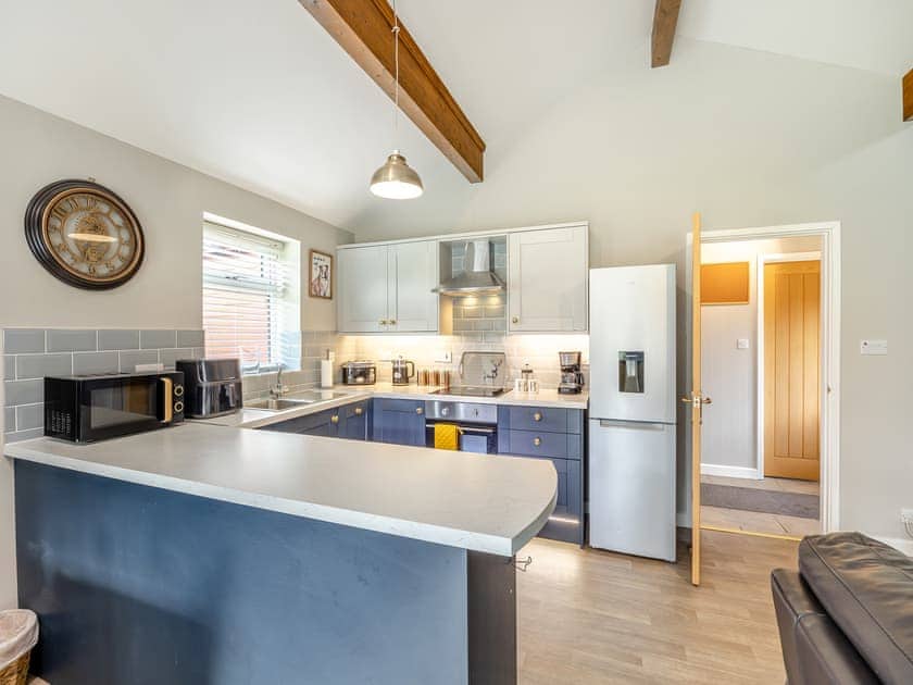 Well-appointed kitchen area with breakfast bar | Humphrey-Basil Lodge - Birchdale Lodges & Alpaca’s, Norton Disney, near Lincoln