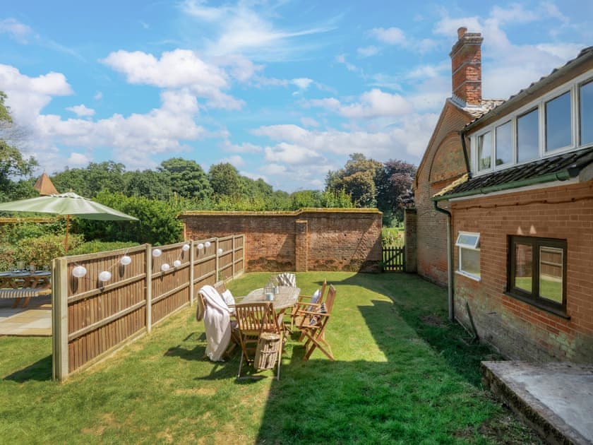 Paved and raised patio with wooden garden furniture | Hall Cottage, Gresham, near Sheringham