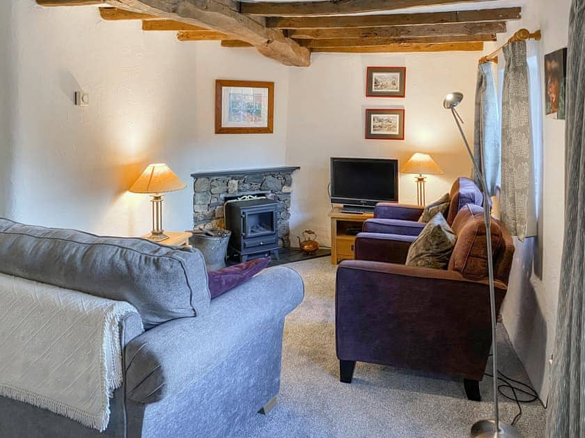 Beamed living room with feature fireplace | Garries Cottage, near Bassenthwaite