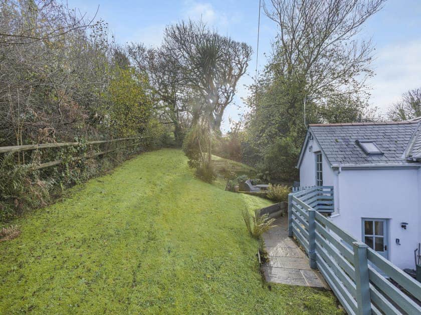 Large garden with patio, sitting-out area and furniture | Thimble Cottage, Hartland