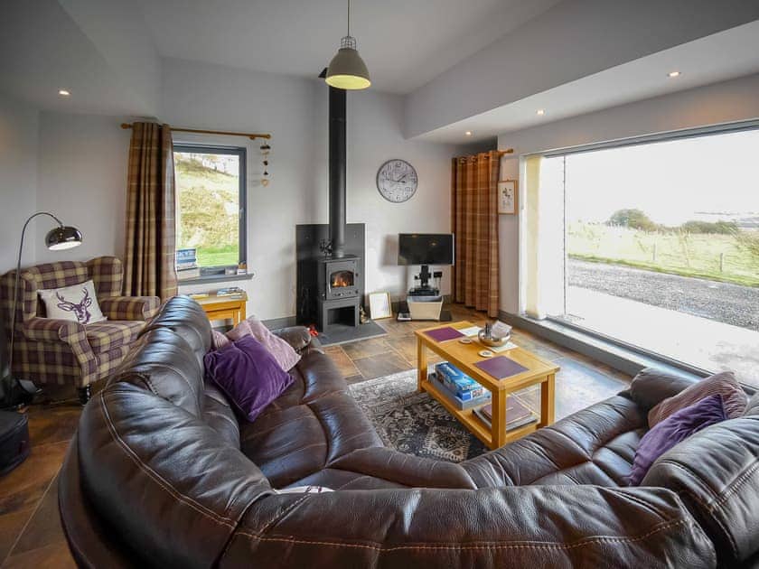 Comfortable living area with floor to ceiling windows | Storr - Brogaig Cottages, Brogaig, near Staffin