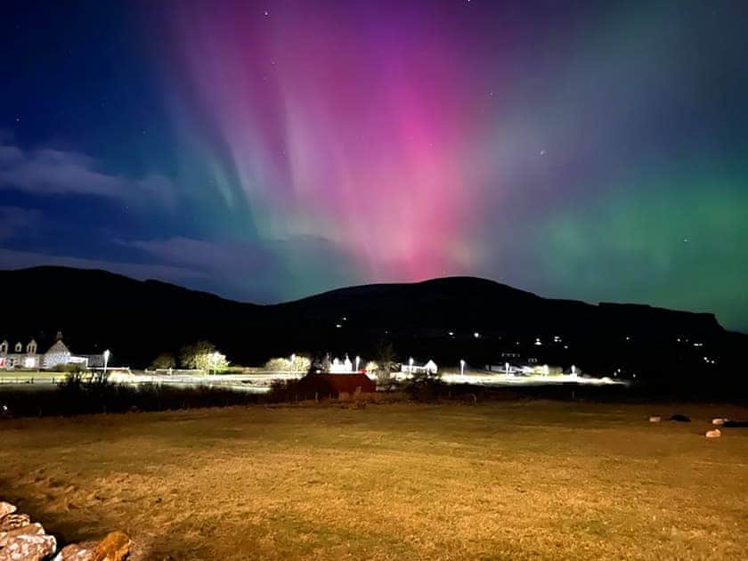 Dramatic night-scape and aurora borealis across Staffin | Storr - Brogaig Cottages, Brogaig, near Staffin