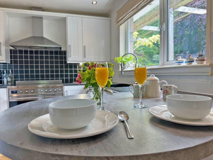 The spacious kitchen has a large window overlooking the courtyard garden | Tigh-na-Creige, Colintraive