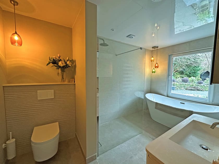 Reverse image of the master bathroom showing the vanity unit and wall cabinet | Tigh-na-Creige, Colintraive