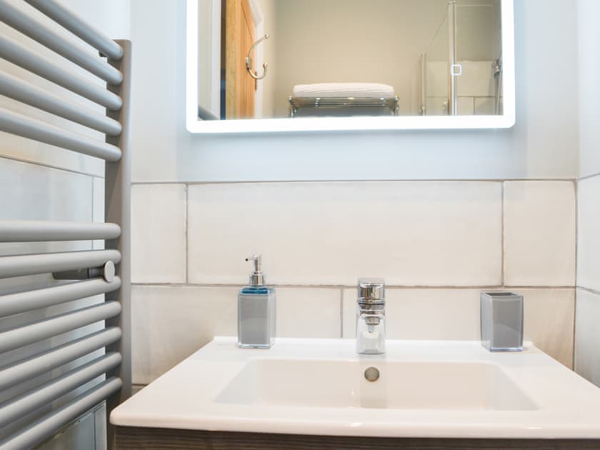 Attractively tiled bathroom with heated towel rail | Ebor Cottage, York